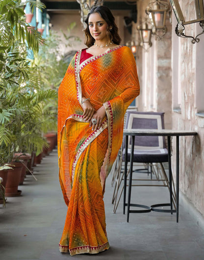 Orange Georgette Bandhani Printed Lace Saree